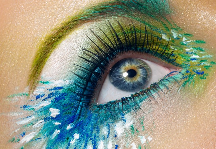 Close-up of eye with peacock feather makeup