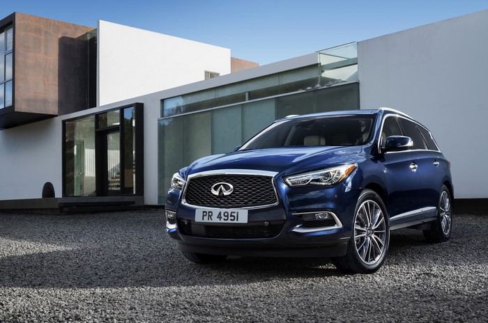 Blue 2016 Infiniti QX60 parked in front of a modern house