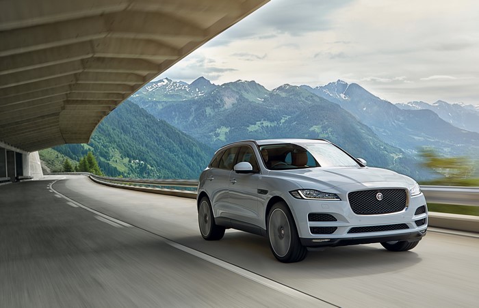 White Jaguar F-Pace driving on mountain road
