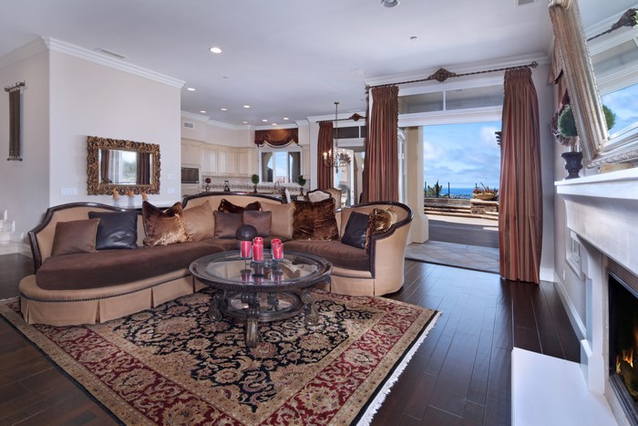 Living room with sofa, table, curtains, and fireplace