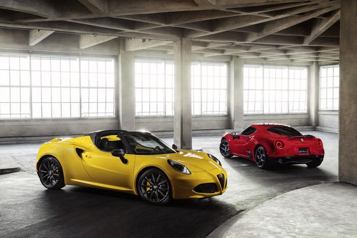 Two Alfa Romeo 4C Spider cars in a garage