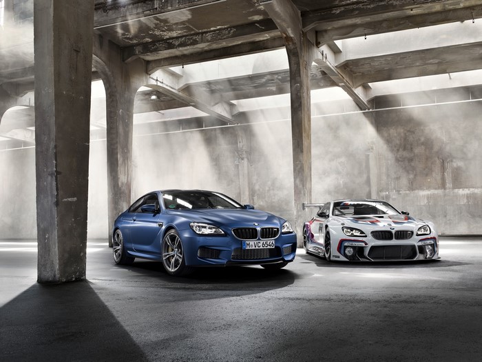 Two BMW M6 cars in a warehouse