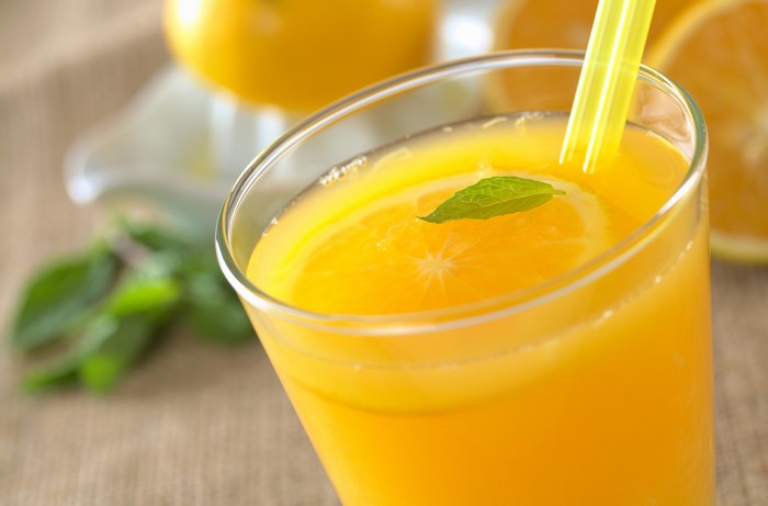 Orange juice in a highball glass with mint and orange slice