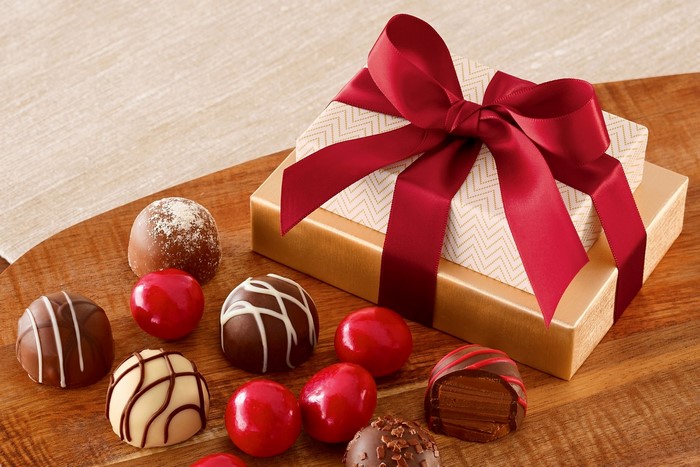 Chocolates and a gift box with a red bow