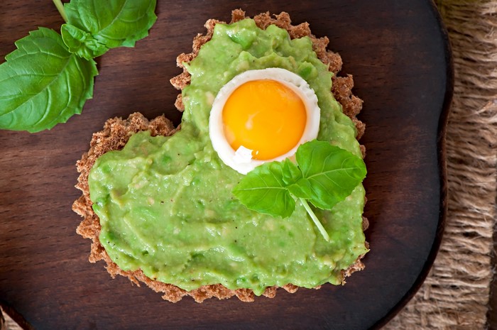 Heart-shaped toast with avocado and egg