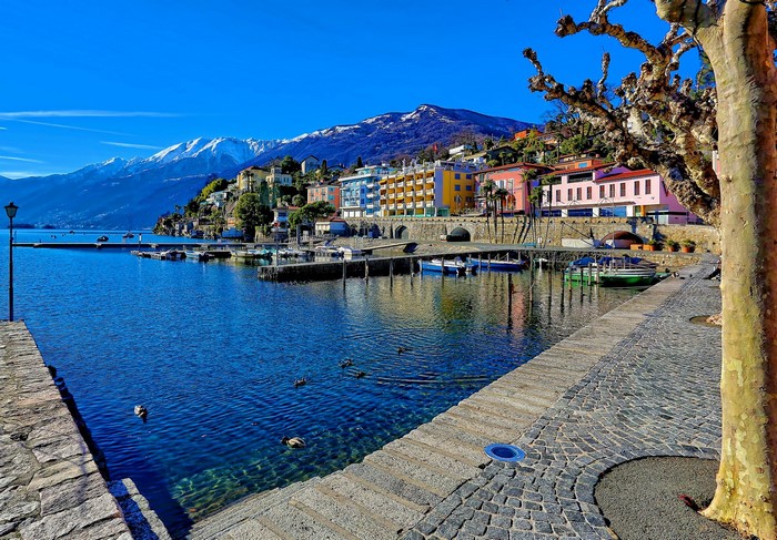 Ascona, Switzerland: Colorful Houses on a Lake with Snow-Capped Mountains