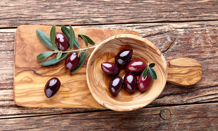 Olives on a wooden board and in a bowl