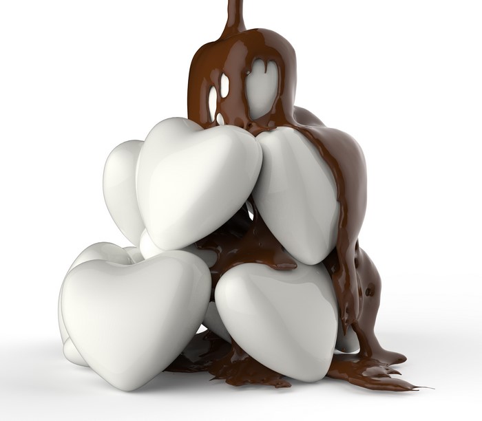 Chocolate poured over white heart candies