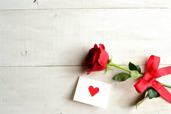 Red Rose with Heart Card and Ribbon on White Wood
