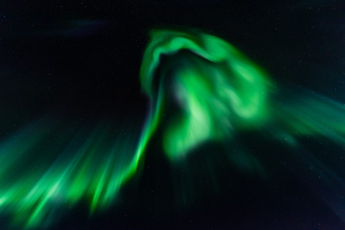 Green Aurora Borealis in a Starry Night Sky