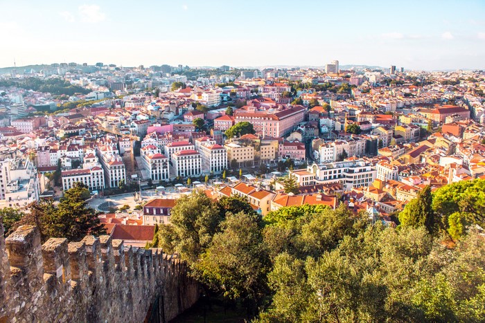Lisbon cityscape with historic castle wall in foreground