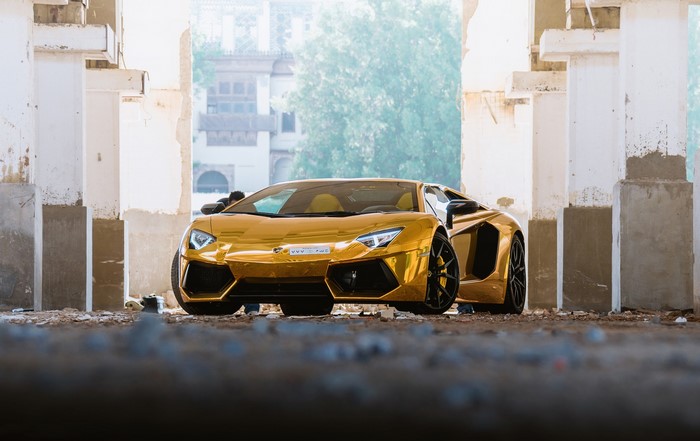 Gold Lamborghini Aventador Roadster in abandoned building