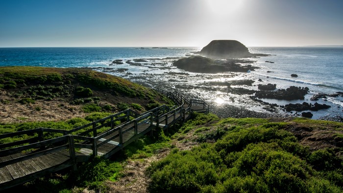 Wooden stairs leading to the ocean coast in Australia