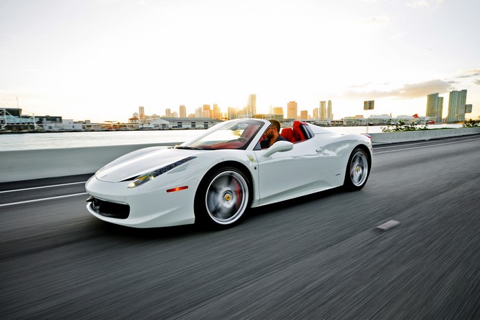 White Ferrari 458 Italia Spider driving on a highway