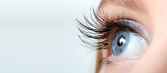 Closeup of a blue eye with long eyelashes