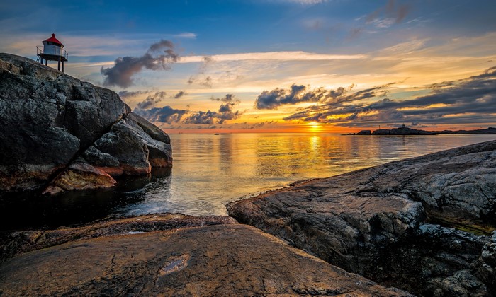 Sunset over the coast of Egersund, Norway with lighthouses