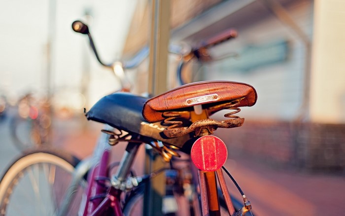 Closeup of a vintage bicycle seat and reflector