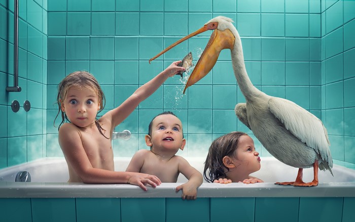 Three children and a pelican in a bathtub