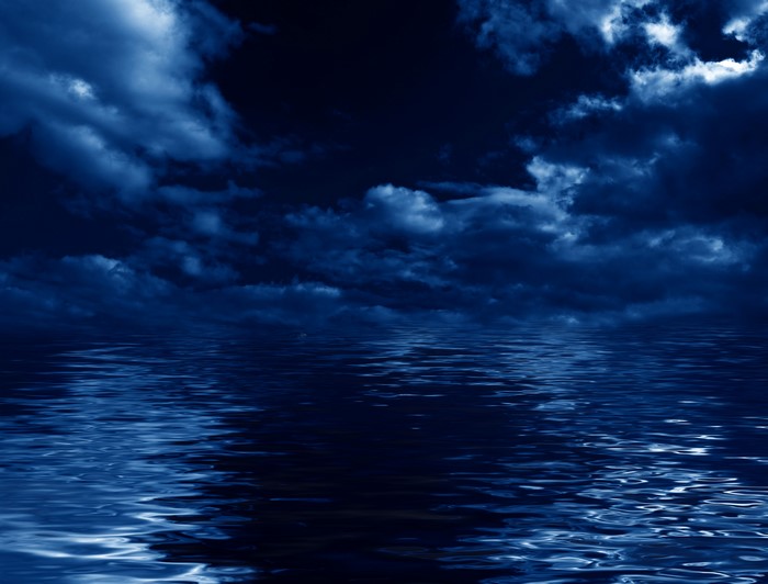 Dark Clouds Over Reflective Water at Night