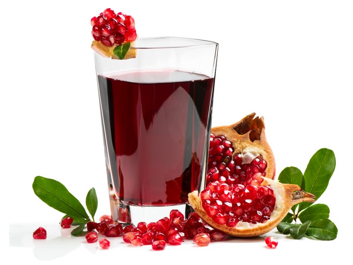 Pomegranate juice in a glass with fresh fruit