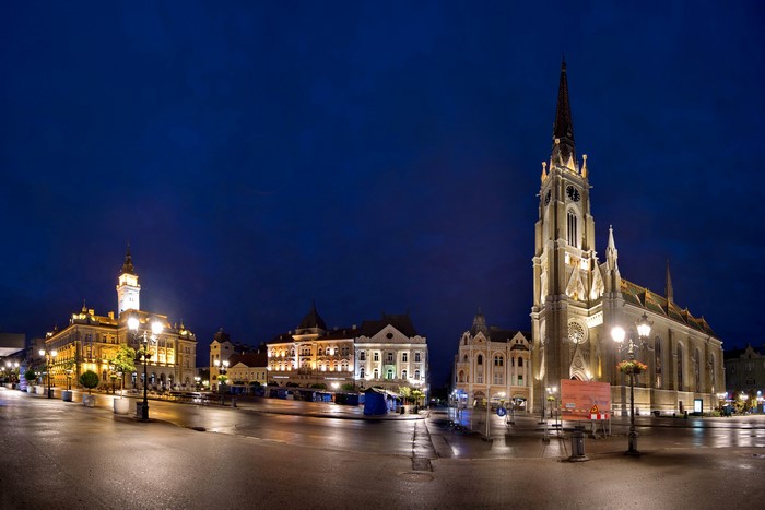 Novi Sad city square at night with church and buildings