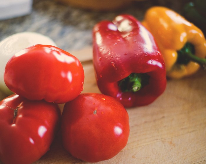 Tomatoes and Bell Peppers on a Cutting Board