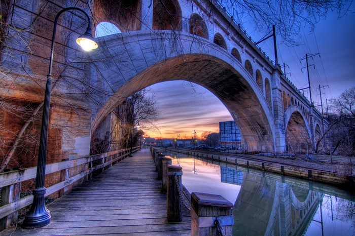 Bridge over canal at dusk with street light