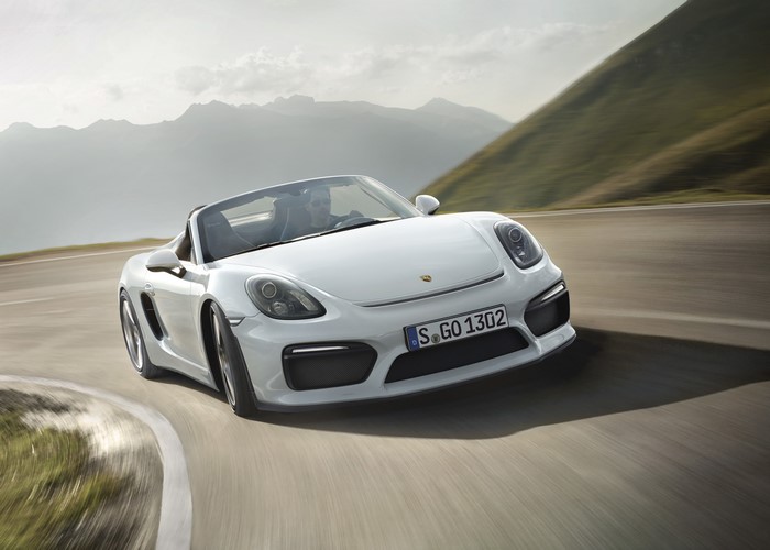 White Porsche Boxster Spyder driving on a mountain road