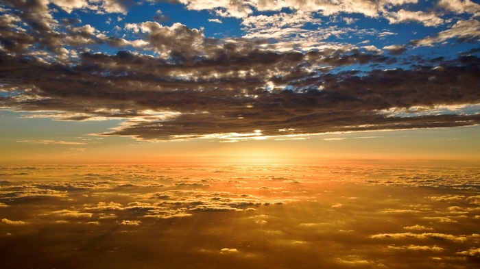 Sunset over clouds from airplane window