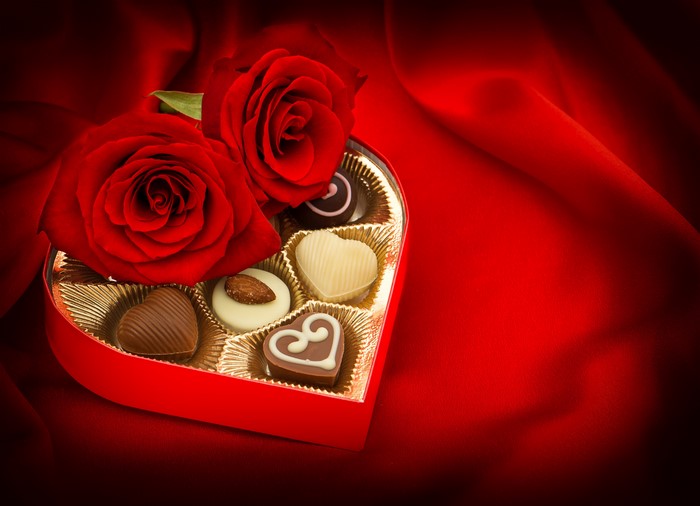 Heart-shaped box of chocolates with red roses
