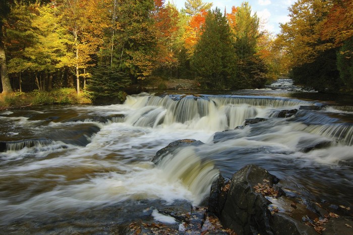 Autumn waterfalls and river in a forest