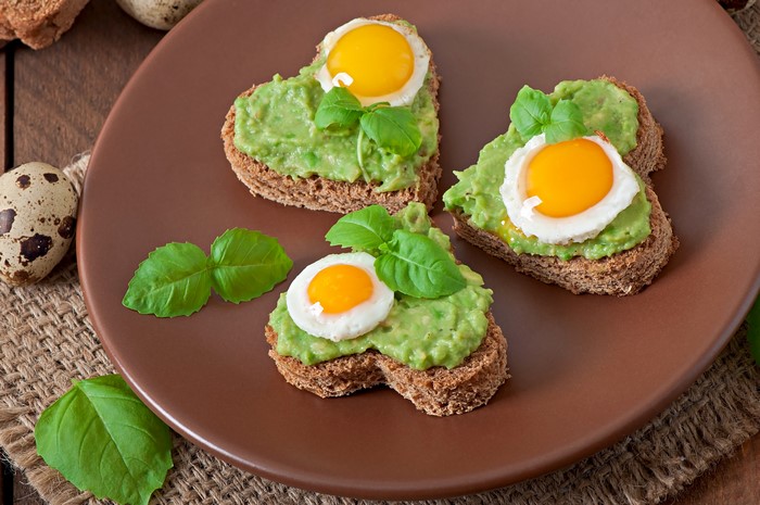 Heart-shaped avocado toast with quail eggs