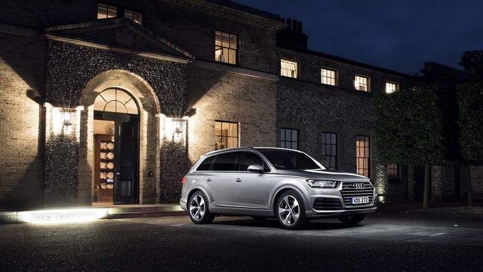 Audi Q7 TDI quattro parked in front of a building at night