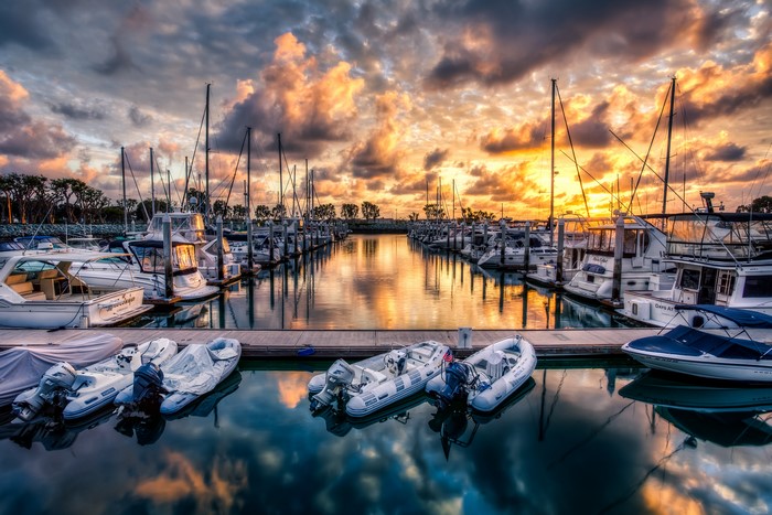 Marina at sunset with boats and dramatic clouds