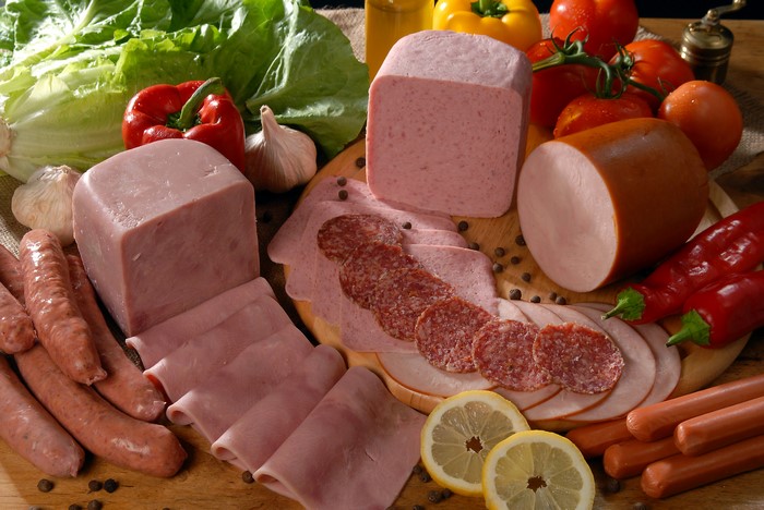 Assortment of Meat Products with Vegetables and Lemons