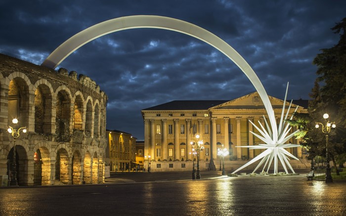Verona Arena and modern art installation at night