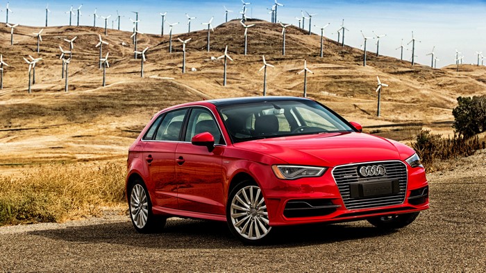 Red Audi A3 e-tron in front of wind turbines