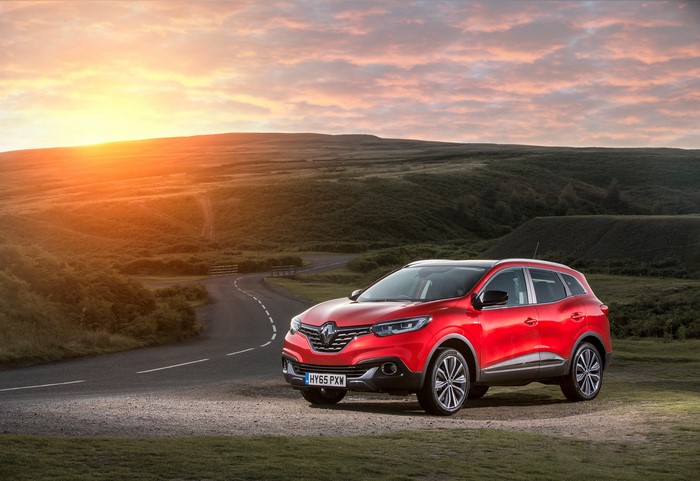 Red Renault Kadjar on a road at sunset