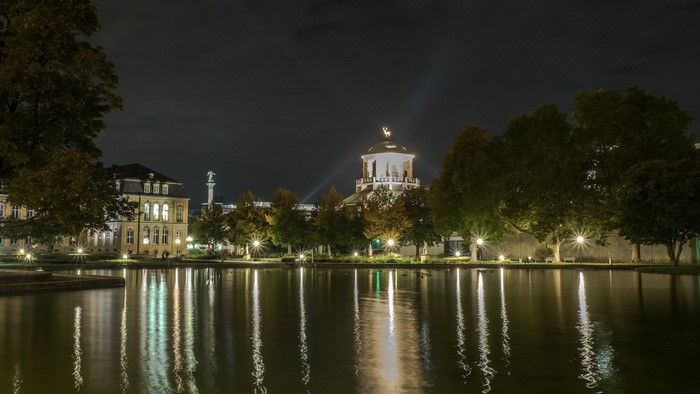 Pond and buildings at night in Stuttgart, Germany