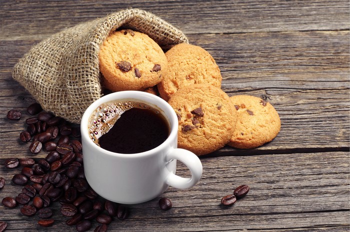 Coffee cup with cookies and coffee beans