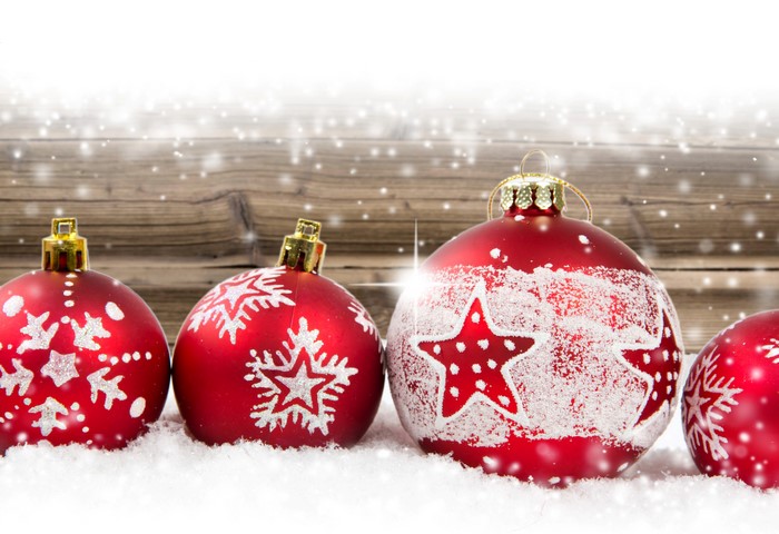 Christmas ornaments in snow with wooden background