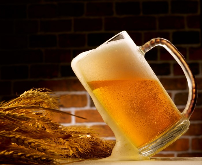 Beer Mug with Wheat and Brick Background