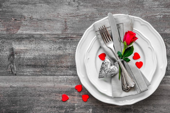 Table setting with rose, heart, and cutlery