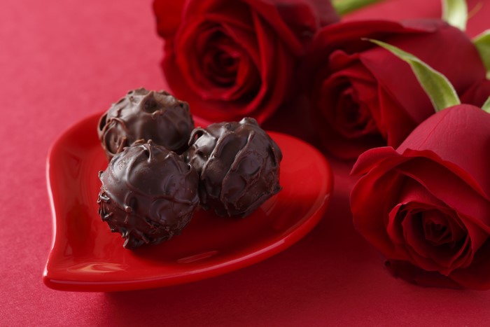 Red Roses and Chocolate Candies on Heart Plate