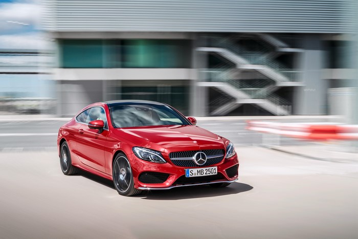 Red Mercedes-Benz C-Class Coupe driving