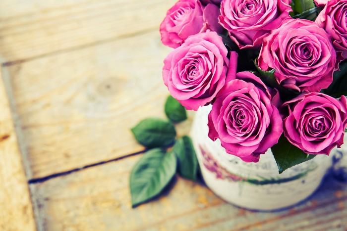 Pink Roses in a Vase on Wooden Surface