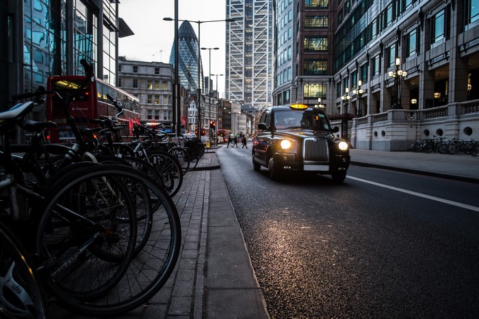 London street with black cab and bicycles
