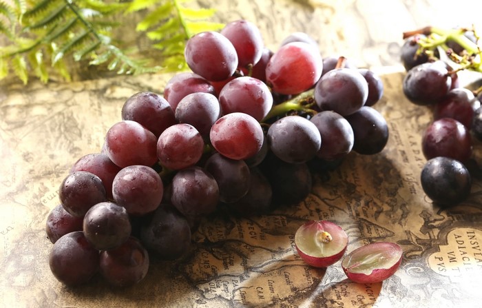 Red and purple grapes on a map