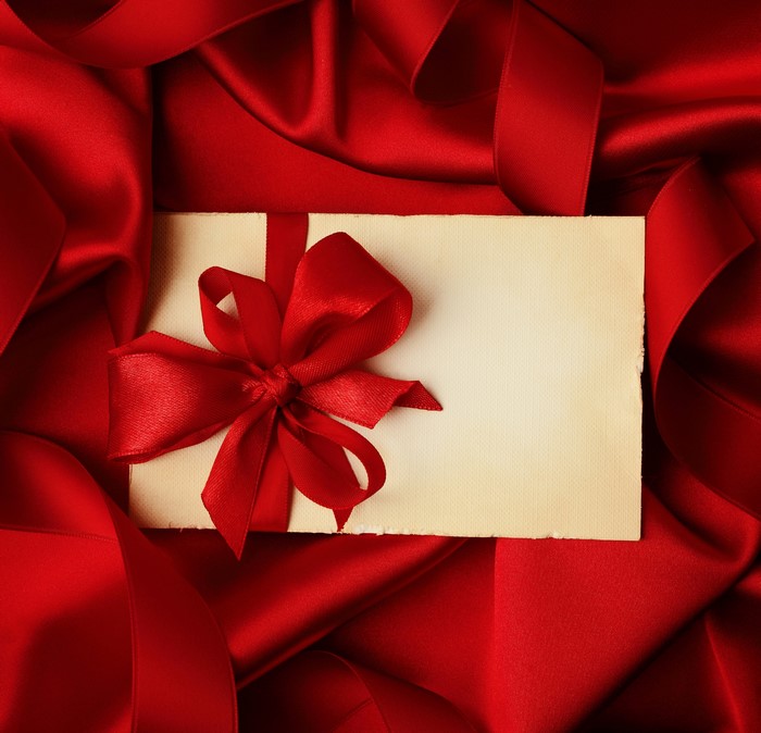 Red ribbon and bow on a blank card
