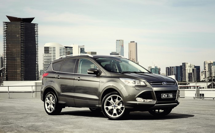 Ford Kuga SUV parked on rooftop with city skyline